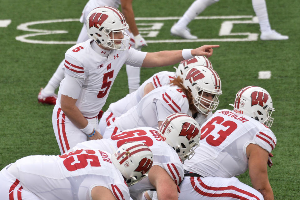 Dec 12, 2020; Iowa City, Iowa, USA; Wisconsin Badgers quarterback Graham Mertz (5) leads the offense against the Iowa Hawkeyes during the first quarter at Kinnick Stadium. Mandatory Credit: Jeffrey Becker-USA TODAY Sports