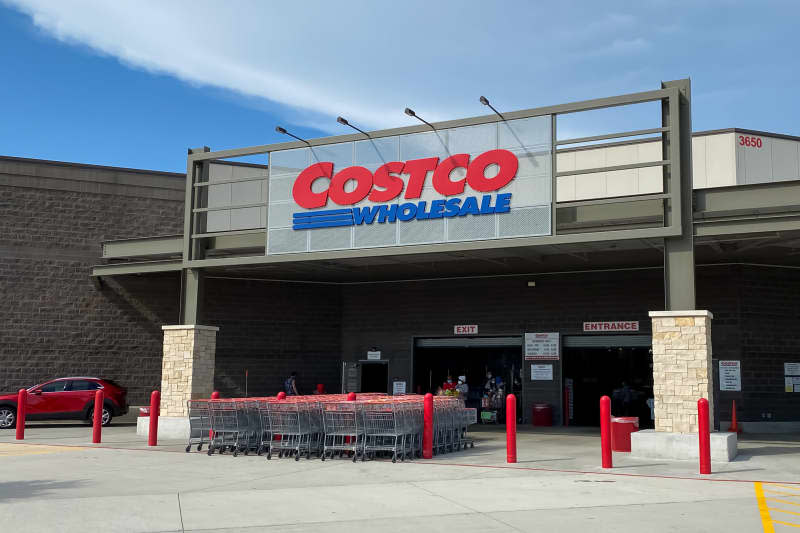 Mckinney, TX / USA - August 12, 2020: Costco Wholesale Entrance with shopping carts and customers in a sunny day