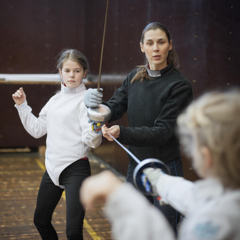 Woman teaching a fencing lesson