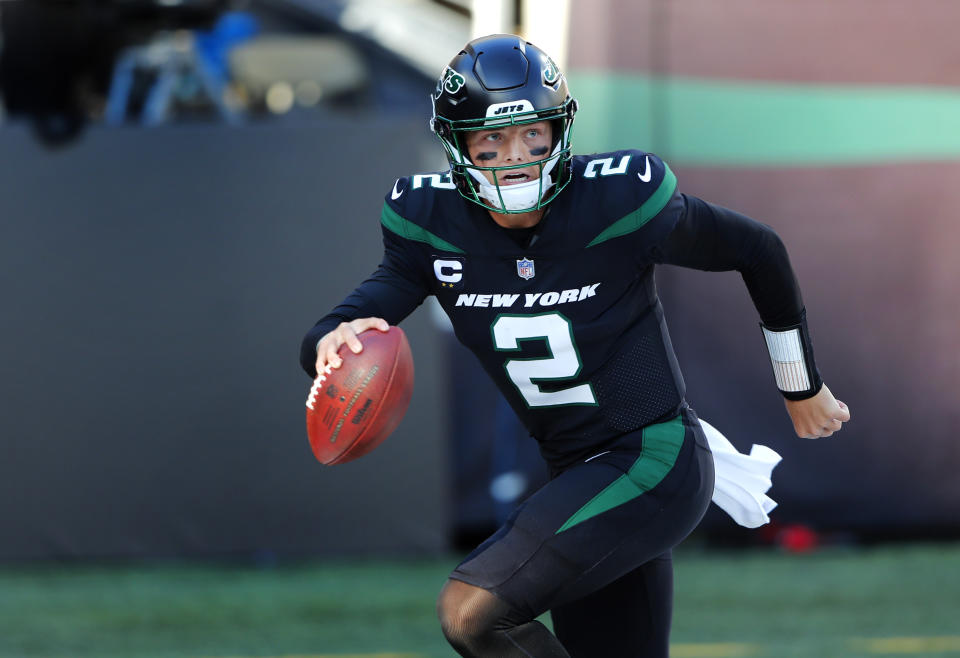 New York Jets quarterback Zach Wilson (2) scrambles against the New England Patriots during the second half of an NFL football game on Sunday, Oct. 30, 2022, in East Rutherford, N.J. (AP Photo/Noah K. Murray)