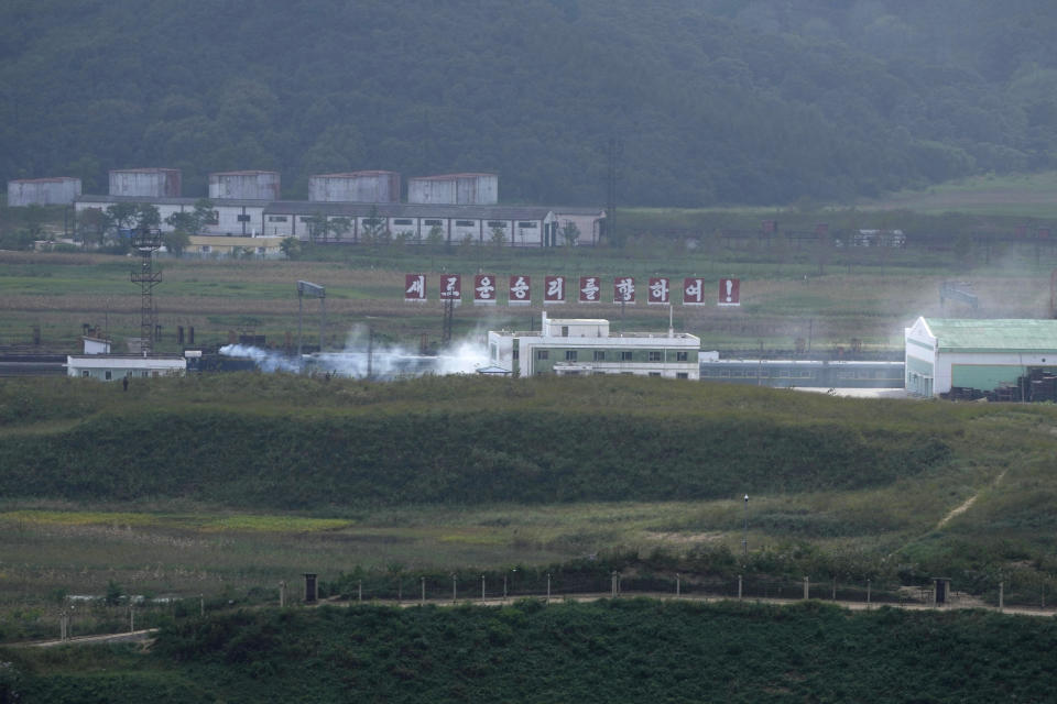 A green train with yellow trimmings, resembling one used by North Korean leader Kim Jong Un on his previous travels, is seen steaming by a slogan which reads "Towards a new victory" on the North Korea border with Russia and China seen from China's Yiyanwang Three Kingdoms viewing platform in Fangchuan in northeastern China's Jilin province on Monday, Sept. 11, 2023. Russia and North Korea confirmed Monday that North Korean leader Kim Jong Un will visit Russia in a highly anticipated meeting with President Vladimir Putin that has sparked Western concerns about a potential arms deal for Moscow's war in Ukraine. (AP Photo/Ng Han Guan)