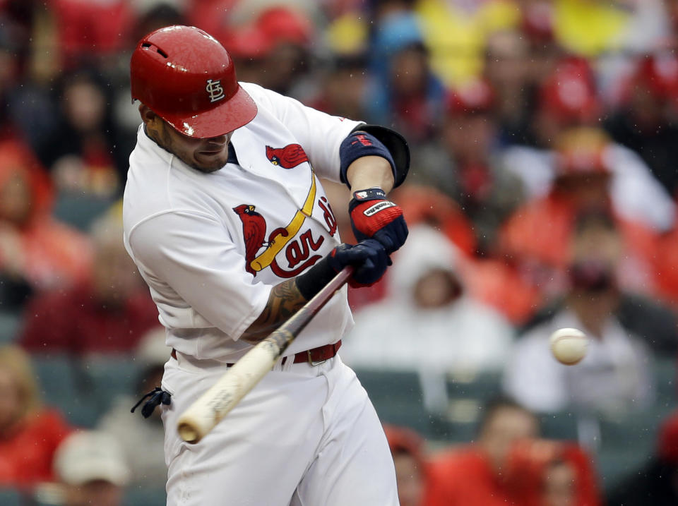 St. Louis Cardinals' Yadier Molina hits a three-run double during the first inning of a baseball game against the Cincinnati Reds, Monday, April 7, 2014, in St. Louis. (AP Photo/Jeff Roberson)