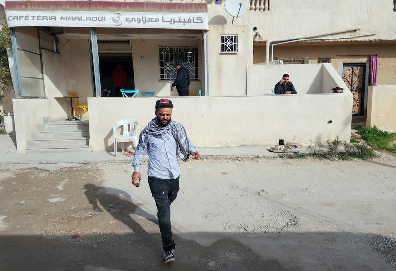 Wadii Jelassi walks near a cafe in Nahli