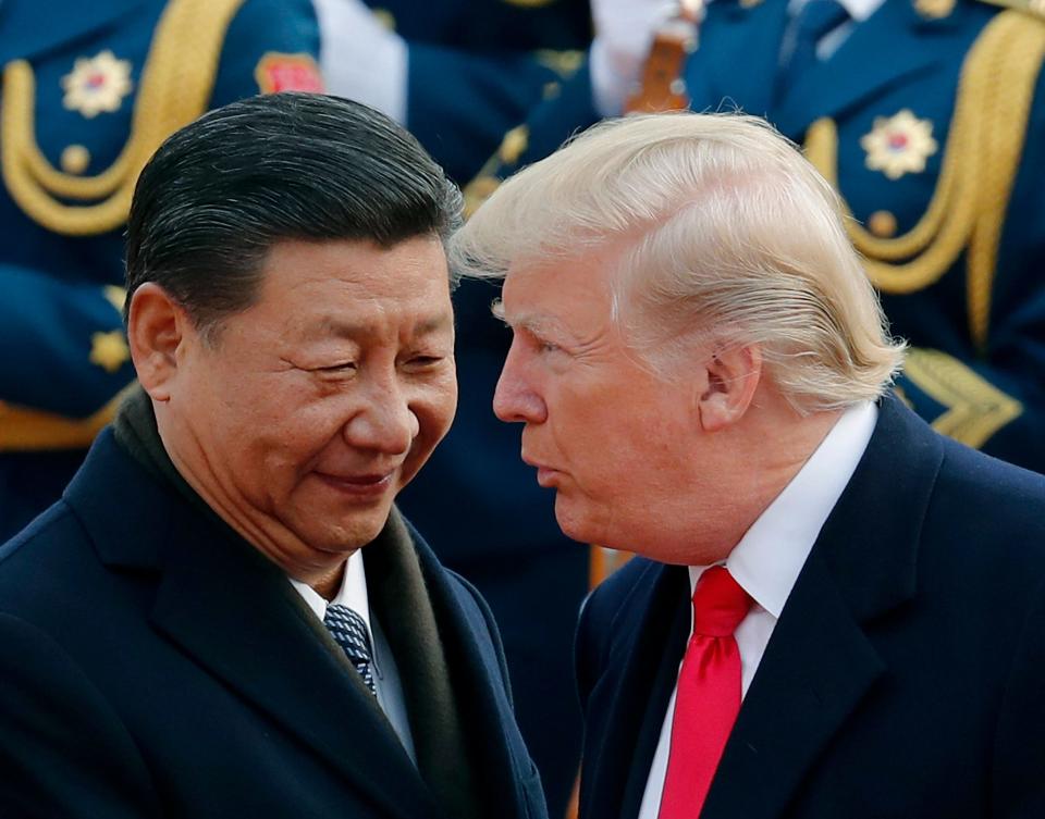 President Donald Trump, right, talks with Chinese President Xi Jinping during a welcome ceremony at the Great Hall of the People in Beijing on Nov. 9, 2017.