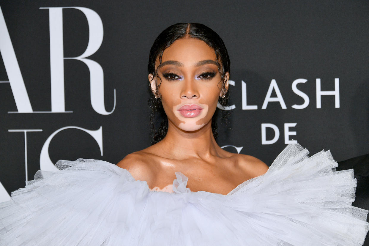 Canadian model Winnie Harlow on red carpet wearing blue frilly dress, Cay Skin Isle Glow Face Moisturizer SPF 45 