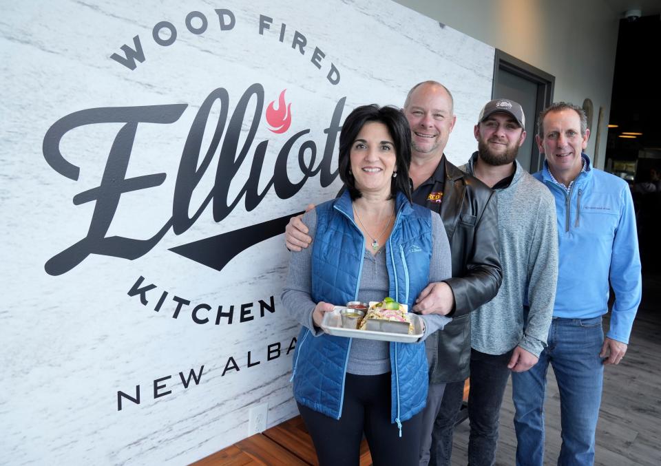 Left to right, Andre Sarap and Mike Sarap, their son Justin Dager, and Tom Sheehan, have opened Elliot's Wood Fired Kitchen & Tap in New Albany, their third restaurant of the same name.