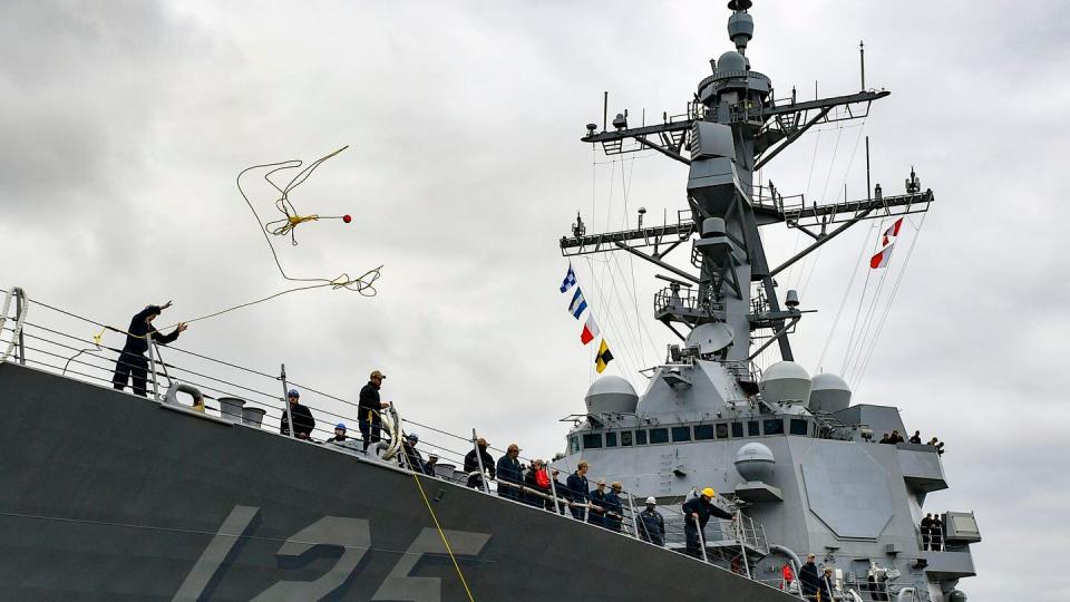 A Sailor throws a mooring line from the Arleigh Burke-class guided missile destroyer USS Jack H Lucas (DDG 125) as as the ship arrives pierside at Naval Base San Diego on Oct. 25, 2023. (MC2 Mikal Chapman/US Navy)