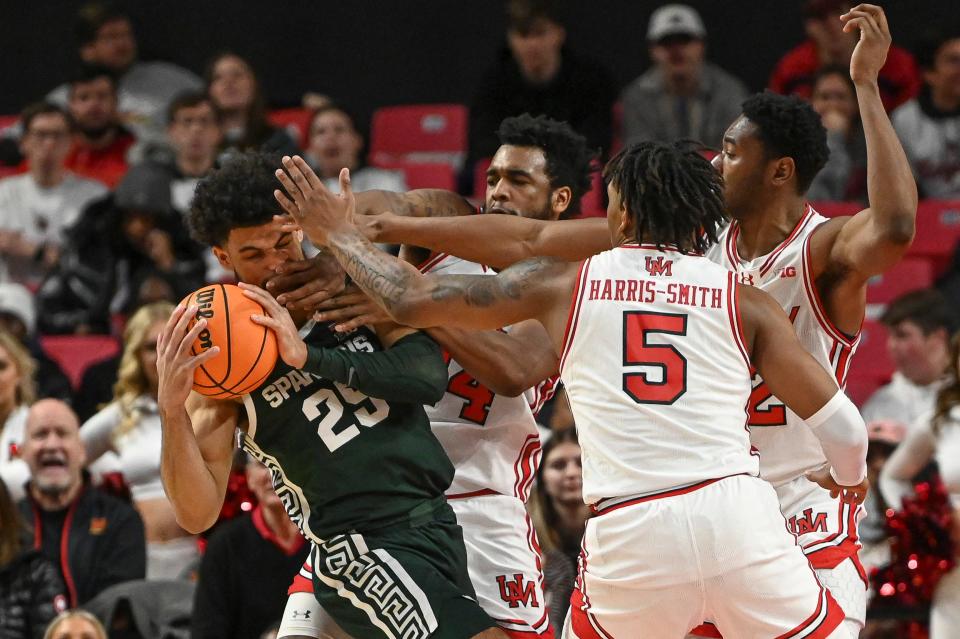 Maryland defenders collapse on Michigan State forward Malik Hall (25) during their game at Xfinity Center.