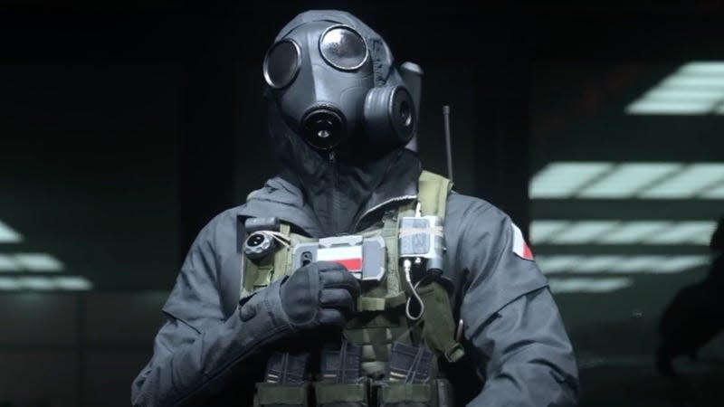 A Call of Duty character wearing a gas mask stands in a dark room.