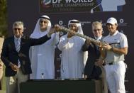 Rory McIlroy of Northern Ireland receives a trophy after winning DP World Tour Championship in Dubai November 22, 2015. REUTERS/Martin Dokoupil