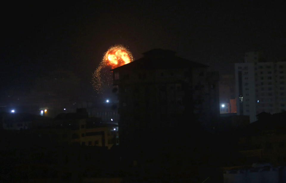 An explosion caused by Israeli airstrikes is seen on Gaza City, early Friday, Friday, March 15, 2019. Israeli warplanes attacked militant targets in the southern Gaza Strip early Friday in response to a rare rocket attack on the Israeli city of Tel Aviv, as the sides appeared to be hurtling toward a new round of violence. (AP Photo/Adel Hana)