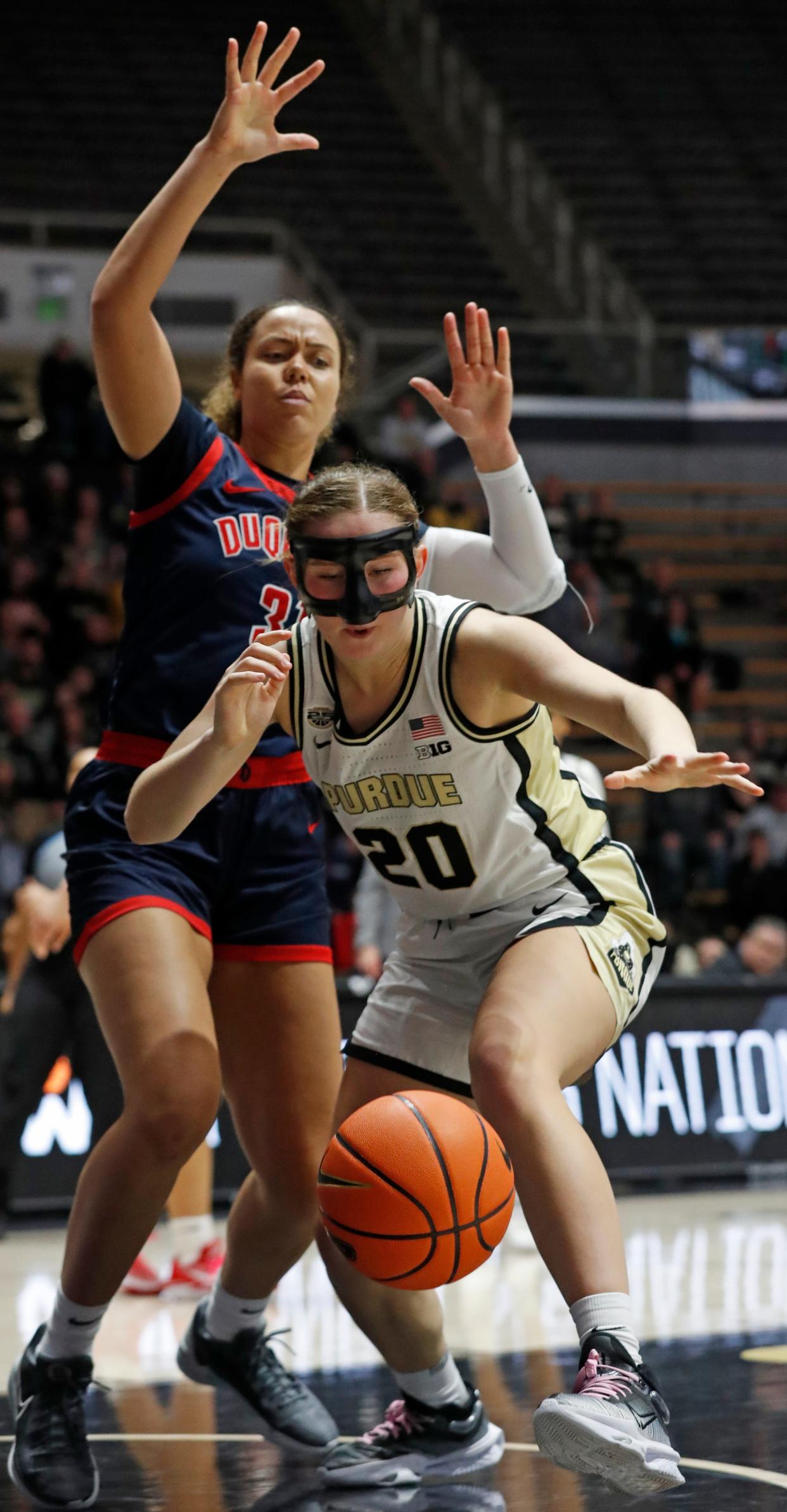 Duquesne Dukes forward Precious Johnson (31) defends Purdue Boilermakers forward Mary Ashley Stevenson (20) during the NCAA WNIT basketball game, Thursday, March 28, 2024, at Mackey Arena in West Lafayette, Ind.