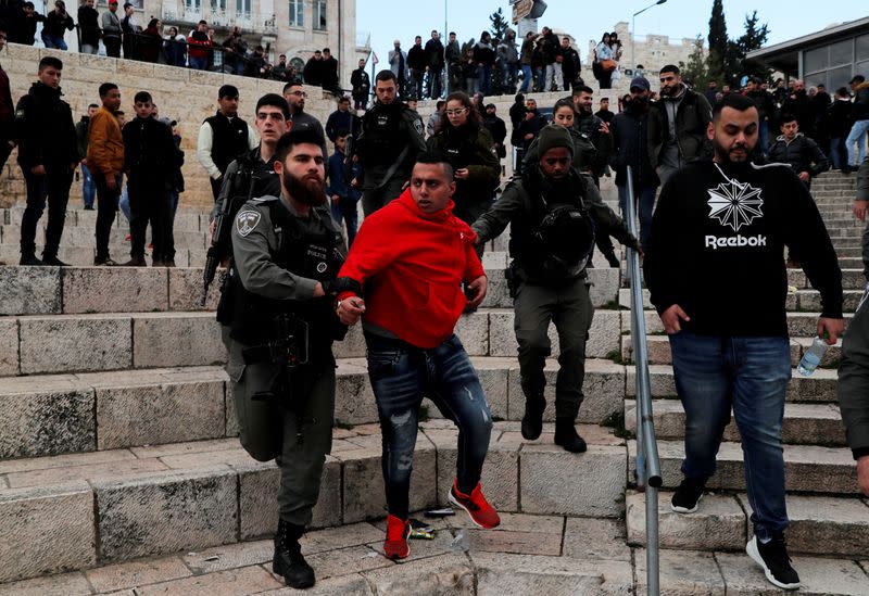 FILE PHOTO: Israeli security forces detain a Palestinian man during a protest against the U.S. president Donald Trump's Middle East peace plan, in Jerusalem's Old City