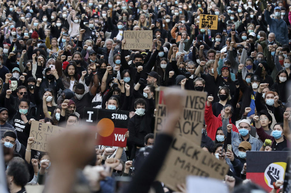 Protesters gather in Sydney, Saturday, June 6, 2020, to support the cause of U.S. protests over the death of George Floyd. Black Lives Matter protests across Australia proceeded mostly peacefully as thousands of demonstrators in state capitals honored the memory of Floyd and protested the deaths of indigenous Australians in custody. (AP Photo/Rick Rycroft)