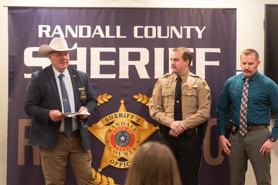 Randall County Sheriff Christopher Forbis presents Deputy Logan Landrum and Sgt. Bryce Burton with service awards Thursday at the Randall County Sheriff's Office outside of Amarillo.