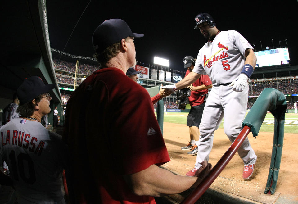 ARLINGTON, TX - OCTOBER 22: Albert Pujols #5 of the St. Louis Cardinals celebrates with teammates after hitting a solo home run in the ninth inning for his third home run of the night during Game Three of the MLB World Series against the Texas Rangers at Rangers Ballpark in Arlington on October 22, 2011 in Arlington, Texas. (Photo by Doug Pensinger/Getty Images)