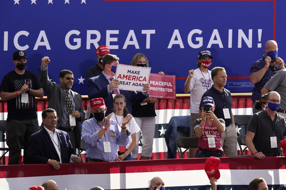 People wait for a campaign rally for President Donald Trump to begin at Manchester-Boston Regional Airport, Friday Aug. 28, 2020 in Londonderry, N.H. (AP Photo/Charles Krupa)