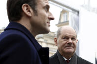 French President Emmanuel Macron, left, and German Chancellor Olaf Scholz attend the presentation of Franco-German industrial projects, Sunday, Jan. 22, 2023 at the Elysee Palace in Paris. France and Germany are seeking to overcome differences laid bare by Russia's war in Ukraine and shore up their alliance with a day of ceremonies and talks Sunday on Europe's security, energy and other challenges. (Benoit Tessier, Pool via AP)