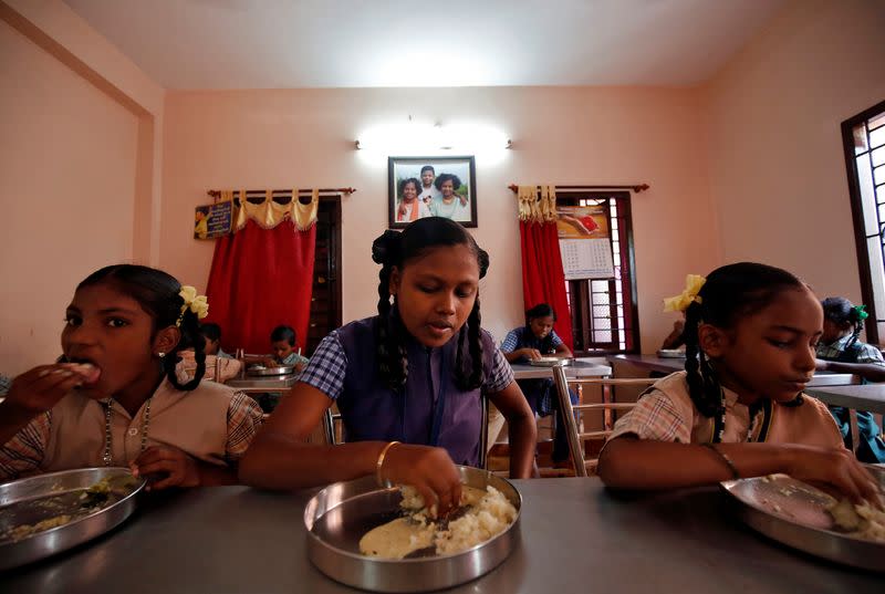 Children staying in the care home set up by Karibeeran Paramesvaran and his wife Choodamani after they lost three children in the 2004 tsunami, eat a meal before heading to school in Nagapattinam district in the southern state of Tamil Nadu, India