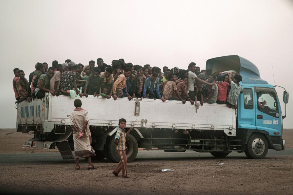 In this July 23, 2019 photo, smugglers move migrants on a pick up truck to a "hosh," a lock up in Arabic, in Ras al-Ara, Lahj, Yemen. Migrants dream of reaching Saudi Arabia, and earning enough to escape poverty by working as laborers, housekeepers, servants, construction workers and drivers. But even if they reach their destination, there is no guarantee they can stay; the kingdom often expels them. (AP Photo/Nariman El-Mofty)