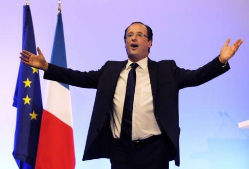 France's opposition Socialist Party (PS) candidate for the 2012 French Presidential election Francois Hollande waves on stage after the announcement of the estimated results of the first round of the French 2012 presidential election, on April 22, 2012 in Tulle, center France. Hollande won the first round