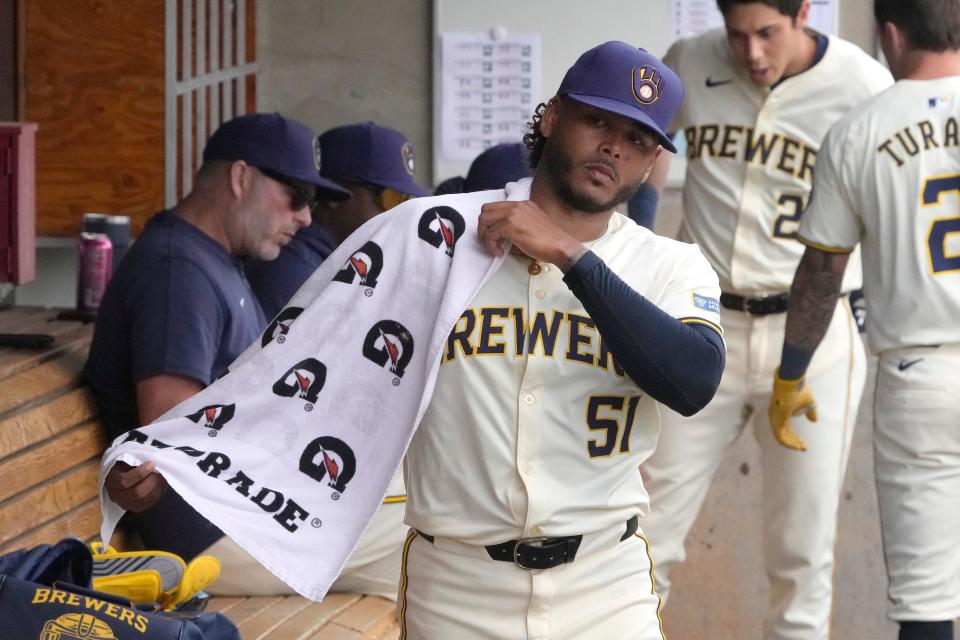 Brewers starting pitcher Freddy Peralta wraps his arm between innings Saturday at American Family Fields of Phoenix.