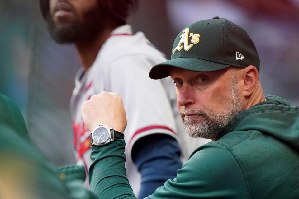 Oakland Athletics manager Mark Kotsay watches from the dugout during the team's baseball game against the Atlanta Braves Wednesday, June 8, 2022, in Atlanta. (AP Photo/John Bazemore)