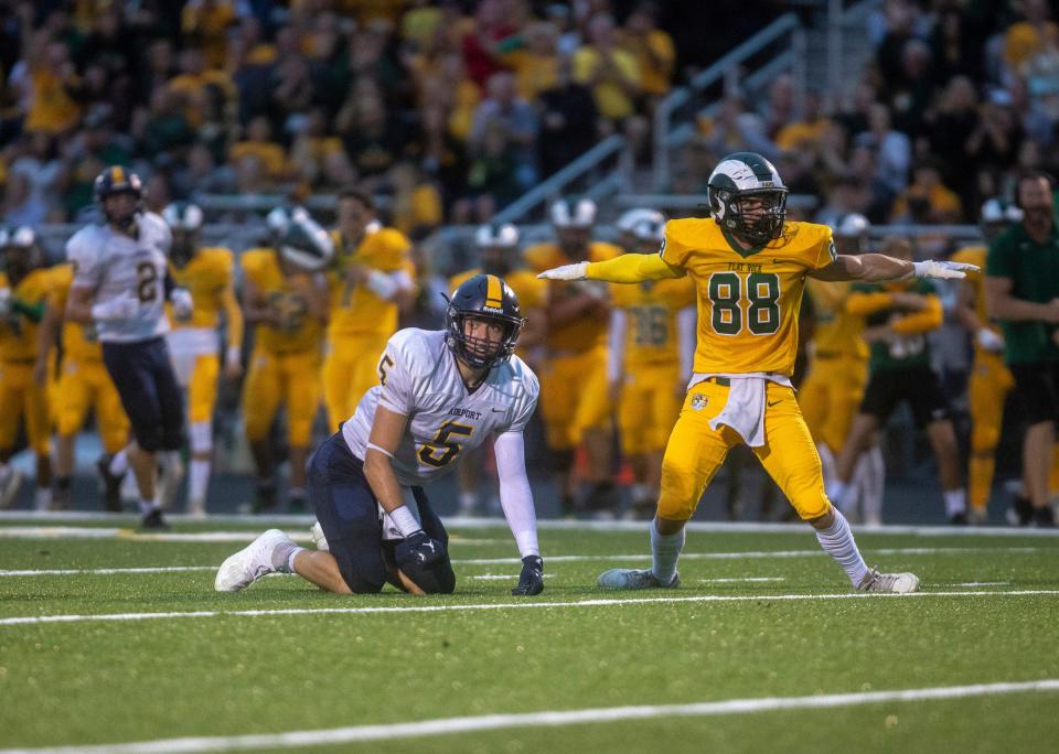 Nolan Zajac (5) kneels for Carleton Airport as Jaycob Pieprzyk (88), a Flat Rock defender, signals an incomplete pass at Flat Rock High School on Friday, Sept. 8, 2023.