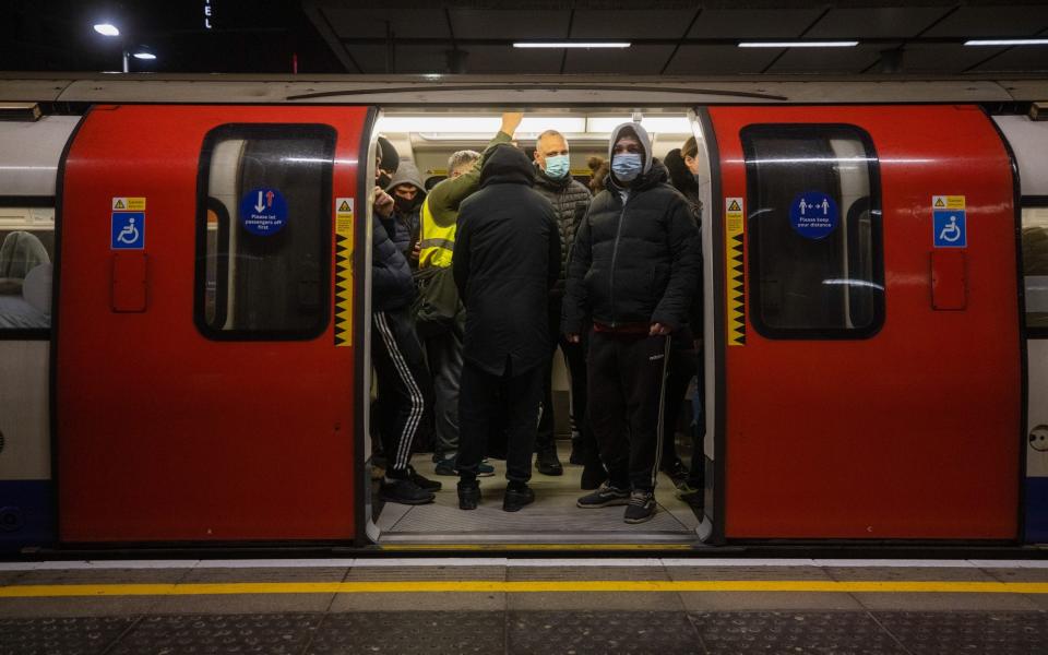 Commuters stand on a Jubilee tube train at Canning Town station in London - Simon Dawson/Bloomberg