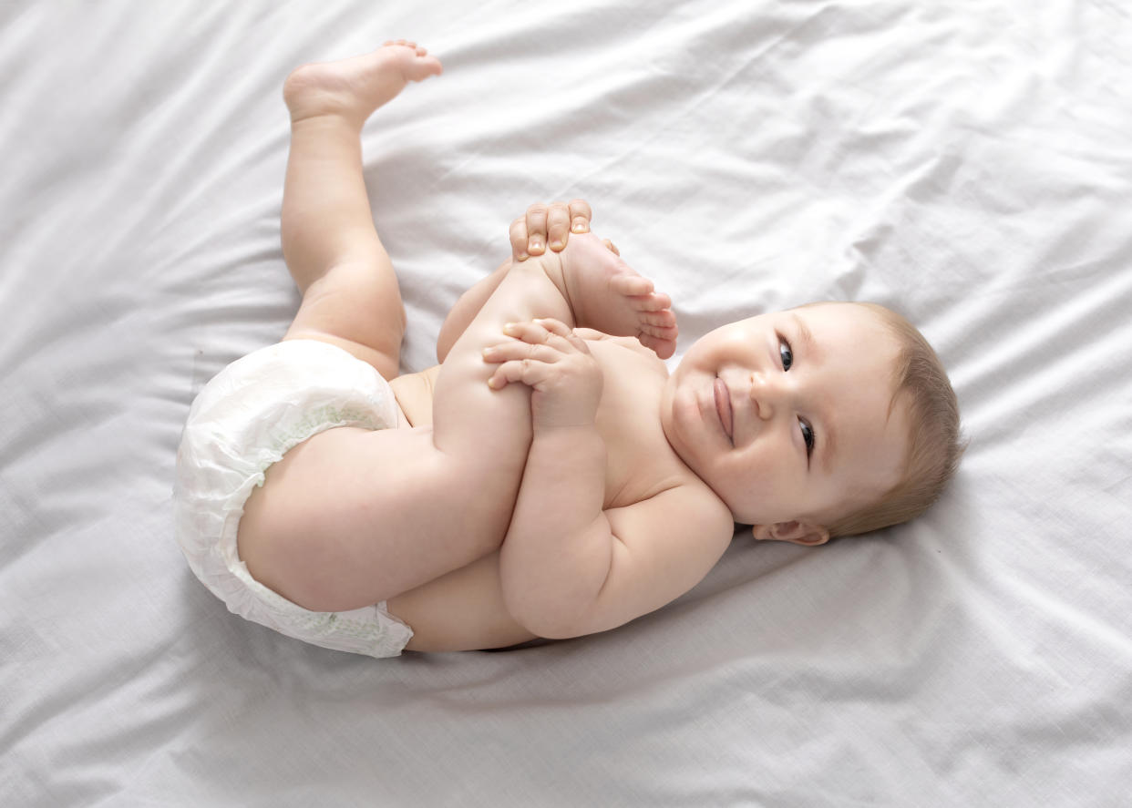 Baby giggling on mat