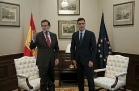 Spain's acting Prime Minister Mariano Rajoy (L) gestures beside Socialists (PSOE) leader Pedro Sanchez at the start of their meeting at Parliament in Madrid, Spain, February 12, 2016. REUTERS/Sergio Perez