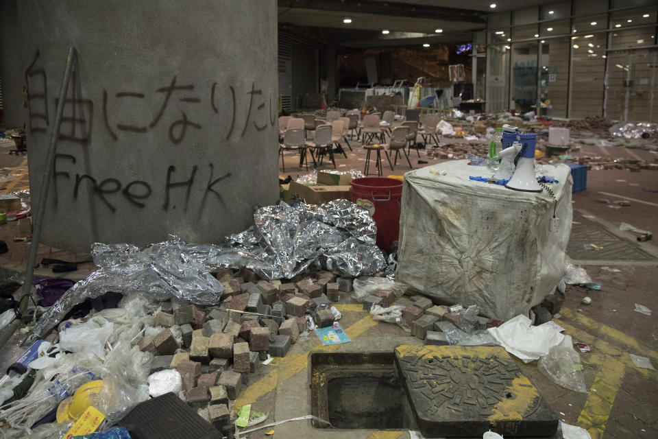 In this Friday, Nov. 22, 2019, photo, debris and graffiti are seen inside the Hong Kong Polytechnic University campus in Hong Kong. Most of the protesters who took over the university have left following clashes with police, but an unknown number have remained inside, hoping somehow to avoid arrest. (AP Photo/Vincent Thian)