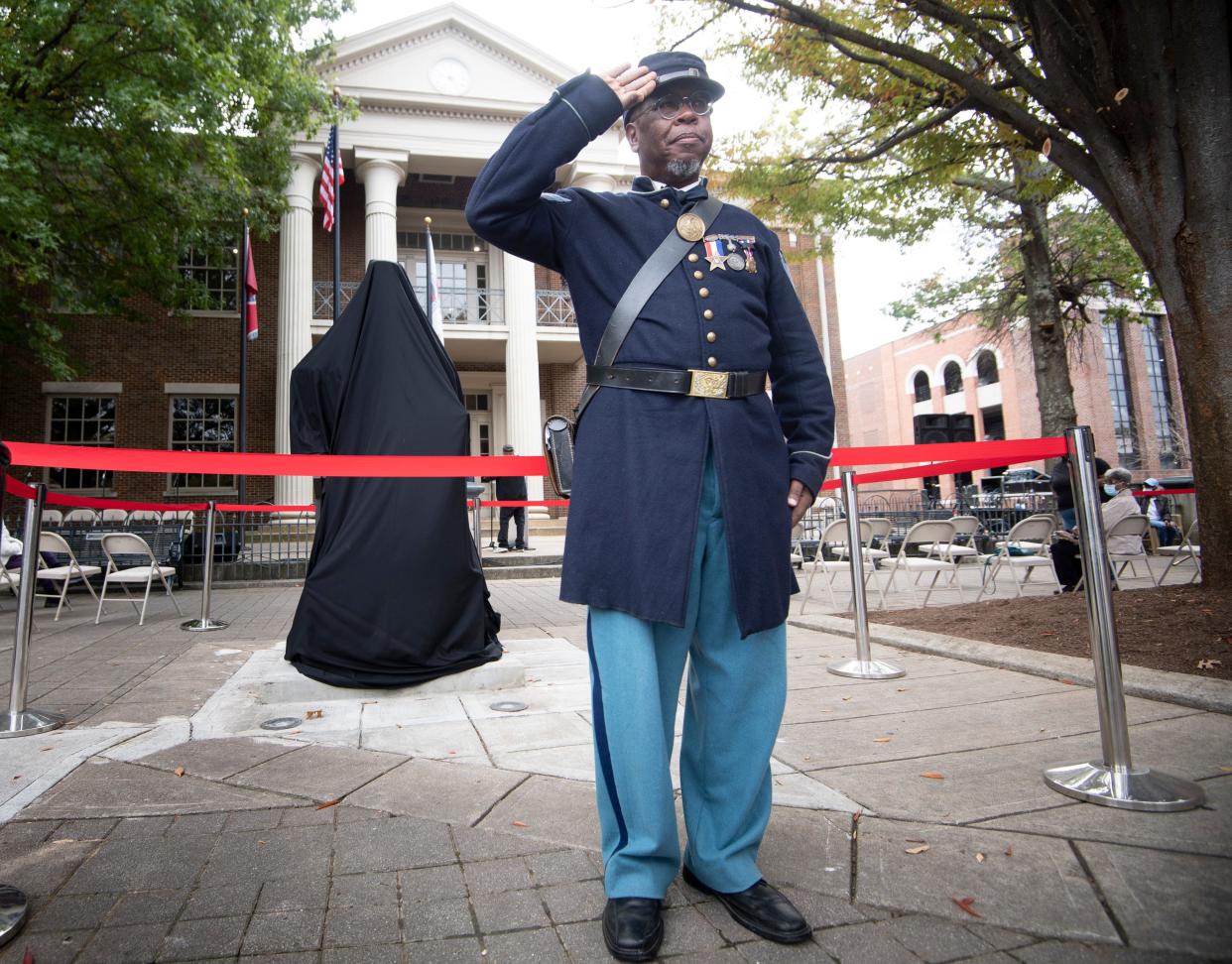 US Colored Troops reenactor Gary Burke stands at attention before the Historic USCT soldier statue unveiling and dedication ceremony at the City Square Saturday, Oct. 23, 2021 in Franklin, Tenn. 