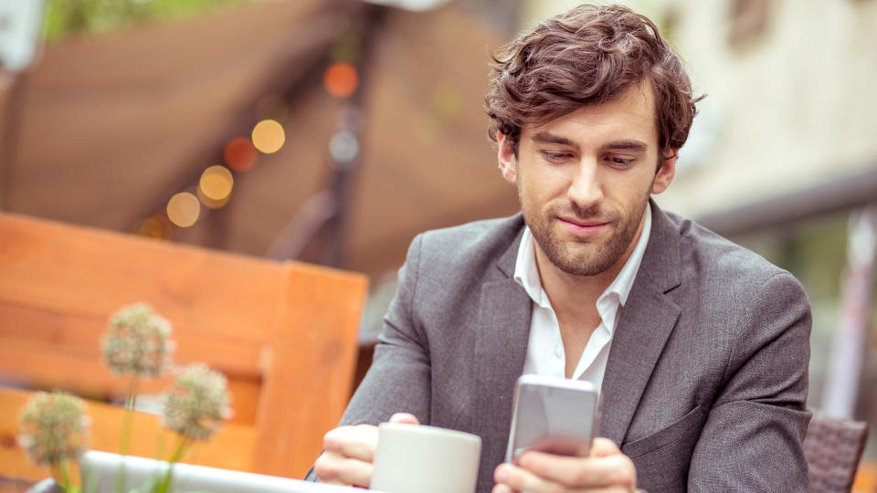 Portrait of a handsome young businessman siting on the terrace of a coffee shop.