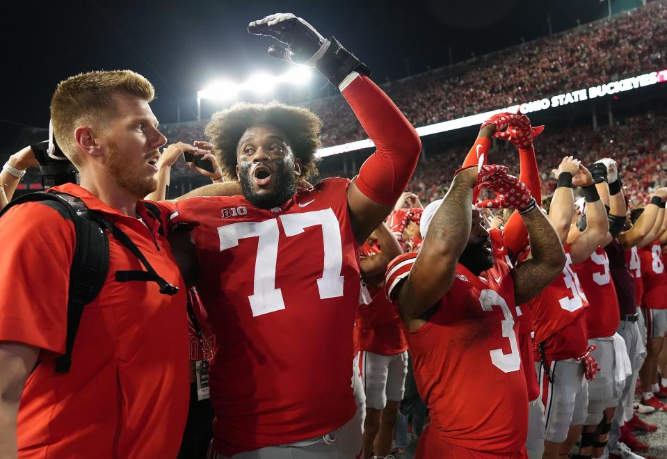 Ohio State Buckeyes offensive lineman Paris Johnson Jr. (77) and Ohio State Buckeyes running back Miyan Williams (3) sings Carmen Ohio after beating Notre Dame Fighting Irish 21-10 in the  NCAA football game at Ohio Stadium.