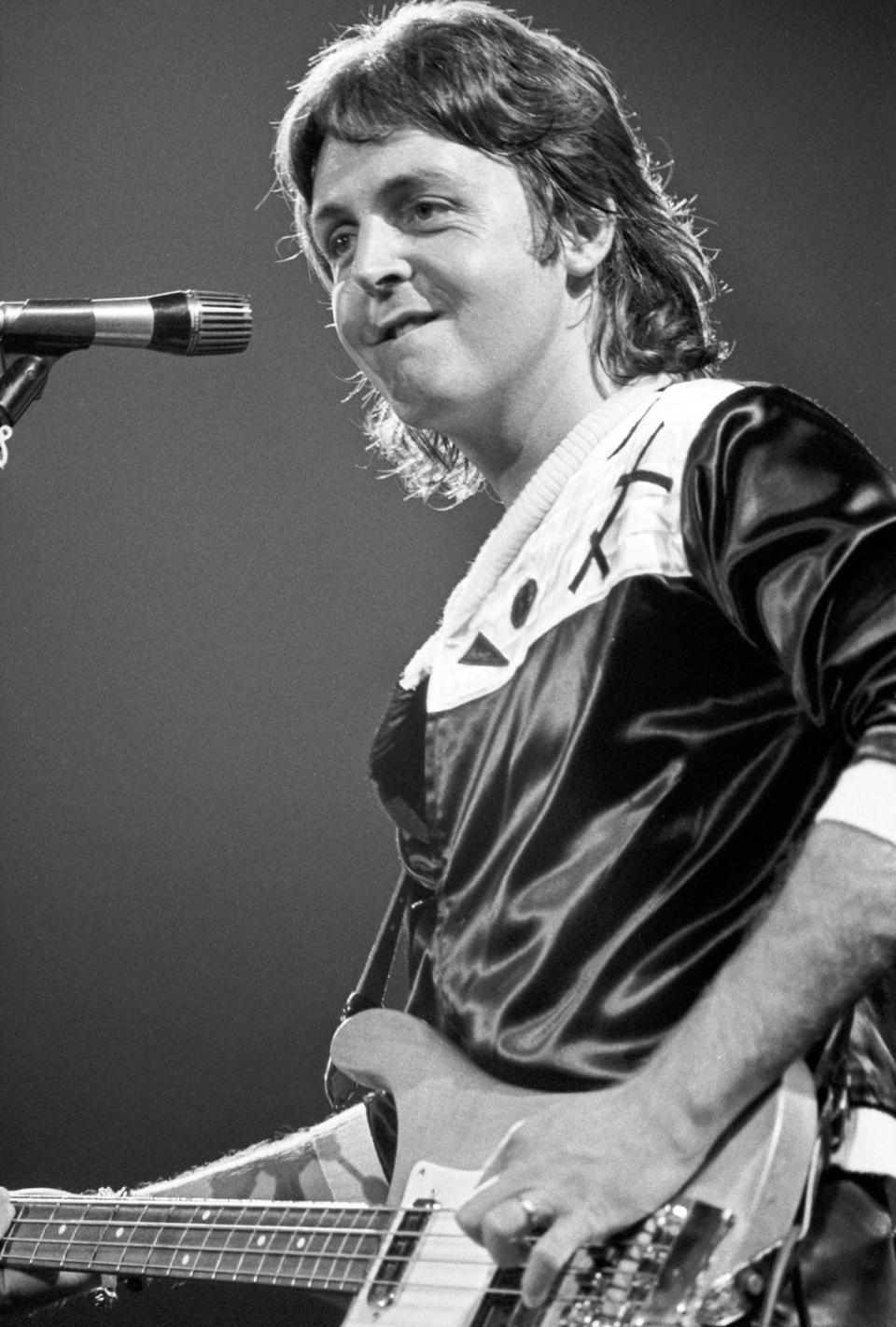 Paul McCartney and Wings opened their first United States tour, “Wings Over America,” at the Tarrant County Convention Center, attracting a packed house which was sold out two months before the show. The ex-Beatle, Paul McCartney, is seen here performing on stage during the concert; 05/03/1976.