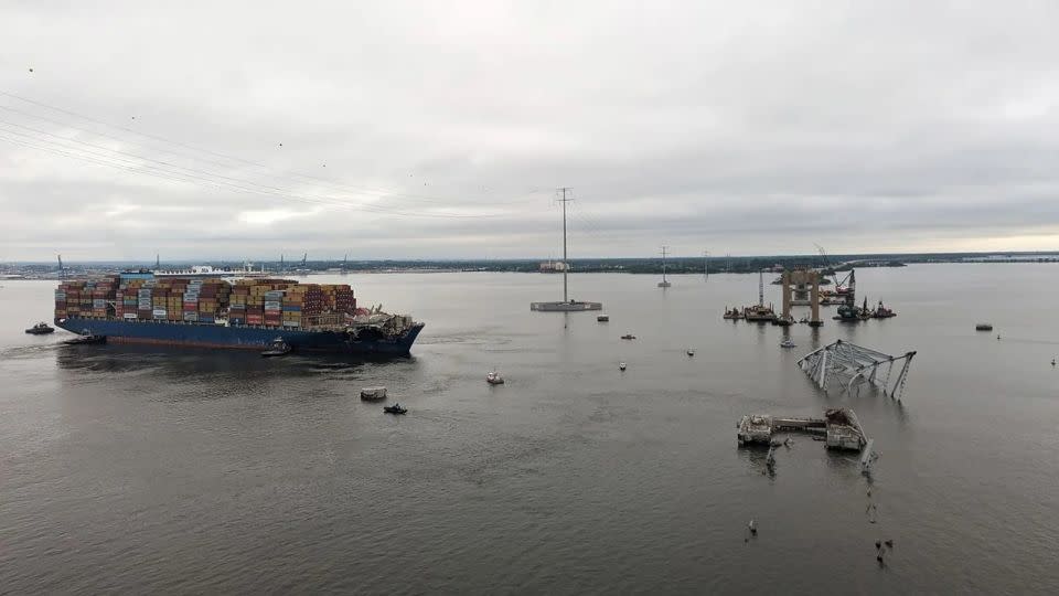 Tugboats move the Dali away from the remnants of the Key Bridge on Monday. - from Key Bridge Unified Command