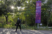 A police officer walks past a G20 Foreign Ministers' Meeting in Nusa Dua, Bali, Indonesia, Thursday, July 7, 2022. Foreign ministers from the Group of 20 leading rich and developing nations are gathering in Indonesia's resort island of Bali for talks bound to be dominated by the conflict in Ukraine despite an agenda focused on global cooperation and food and energy security. (AP Photo/Dita Alangkara)