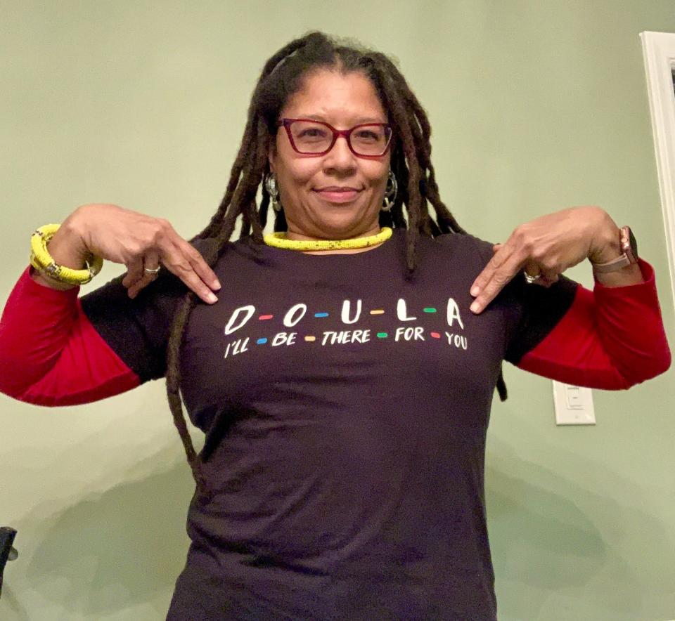 Death doula Raylene Driver Hill of Greensboro, North Carolina, wears one of her collection of appropriate T-shirts.