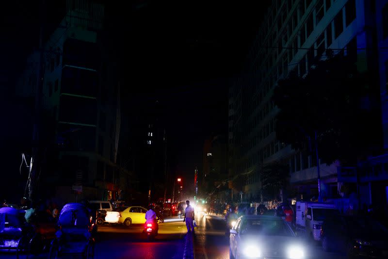 Vehicles are seen on the street during countrywide blackout in Dhaka