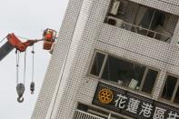 A rescue worker searches for survivors at a damaged building after an earthquake hit Hualien, Taiwan February 7, 2018. REUTERS/Stringer