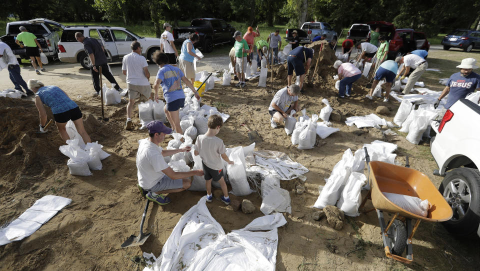 Resident fill sandbags Friday, July 12, 2019, in Baton Rouge, La., ahead of Tropical Storm Barry. The National Weather Service in New Orleans says water is already starting to cover some low lying roads in coastal Louisiana as Tropical Storm Barry approaches the state from the Gulf of Mexico. (AP Photo/David J. Phillip)