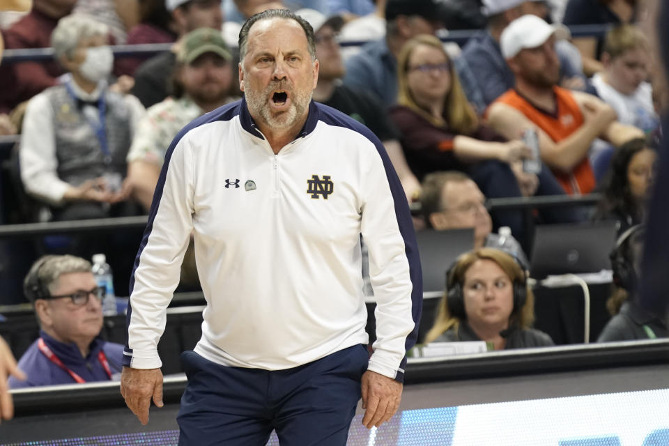 Notre Dame coach Mike Brey directs the team against Virginia Tech during the first half of an NCAA college basketball game at the Atlantic Coast Conference men's tournament in Greensboro, N.C., Tuesday, March 7, 2023. (AP Photo/Chuck Burton)