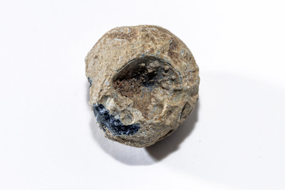 This image provided by Colonial Williamsburg Foundation, shows a piece of lead shot with a tooth mark was excavated in the summer of 2023 by archaeologists at Colonial Williamsburg, a living history museum in Virginia. The piece was found at the site of what is believed to be a military barracks from the American Revolution. Soldiers chewed on the balls because of their sweet taste. The museum announced the site’s discovery on Tuesday, May 14, 2024. (Brendan Sostak/Colonial Williamsburg Foundation via AP)