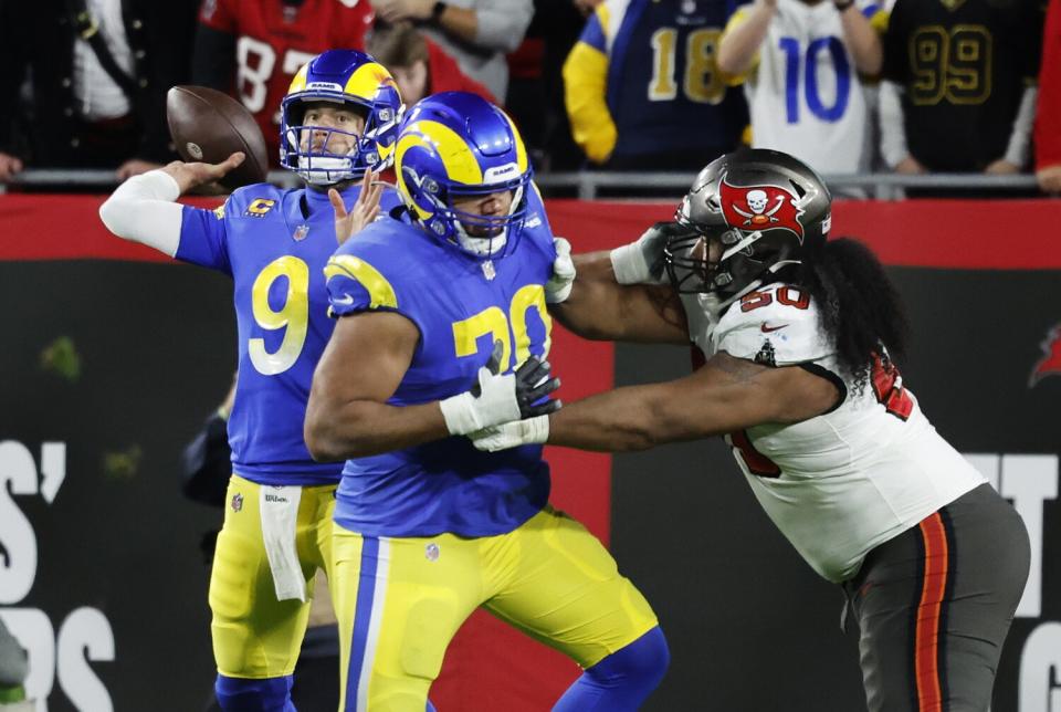 Matthew Stafford unleashes a pass as Rams offensive tackle Joe Noteboom (70) protects against Tampa Bay in the playoffs.