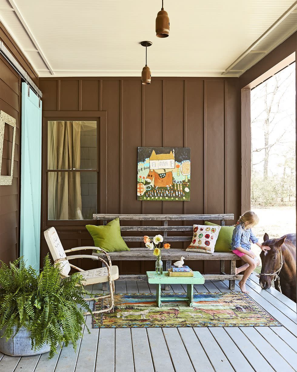 brown farmhouse porch with chippy bench