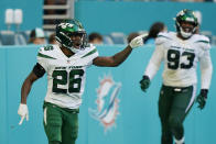 New York Jets cornerback Brandin Echols (26) gestures as he scored a touchdown after intercepting a pass by Miami Dolphins quarterback Tua Tagovailoa (1) during the second half of an NFL football game, Sunday, Dec. 19, 2021, in Miami Gardens, Fla. (AP Photo/Lynne Sladky)