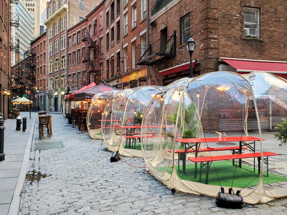 Outdoor dining tables in bubbles along Stone Street during the coronavirus pandemic in downtown Manhattan, New York City NYC