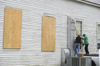 The Rev. Ivory Williams, Sr. and Chris Welch board up the windows of St. John Baptist Church while prepping for Hurricane Delta on Thursday, Oct. 8, 2020, in Charenton, La. (Brad Kemp/The Advocate via AP)