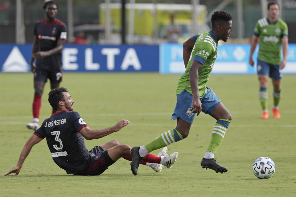 Seattle Sounders defender Kelvin Leerdam, right, moves the ball past Chicago Fire defender Jonathan Bornstein (3) during the first half of an MLS soccer match, Tuesday, July 14, 2020, in Kissimmee, Fla. (AP Photo/John Raoux)